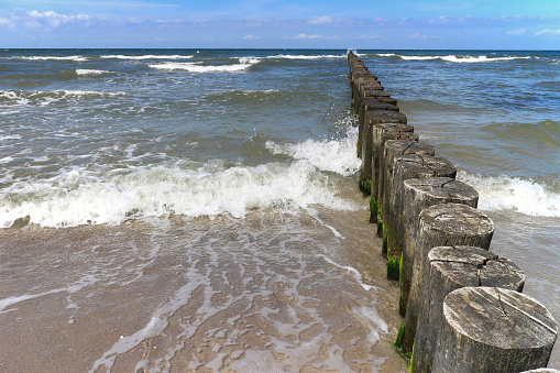 Wooden groynes leading into the Baltic Sea