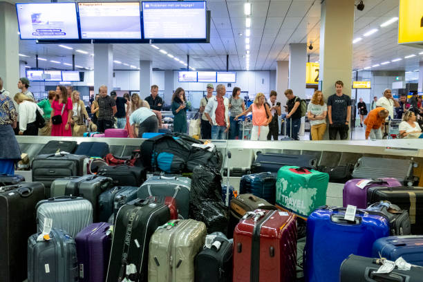 People waiting in line for their luggage , Schipol Airport stock photo