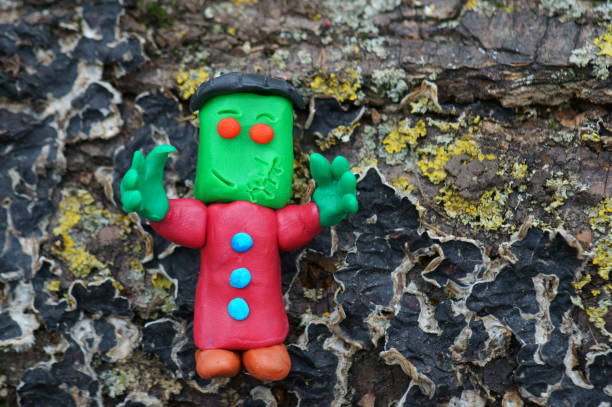 istock Frankenstein figurine on the background of tree bark. 1408239695