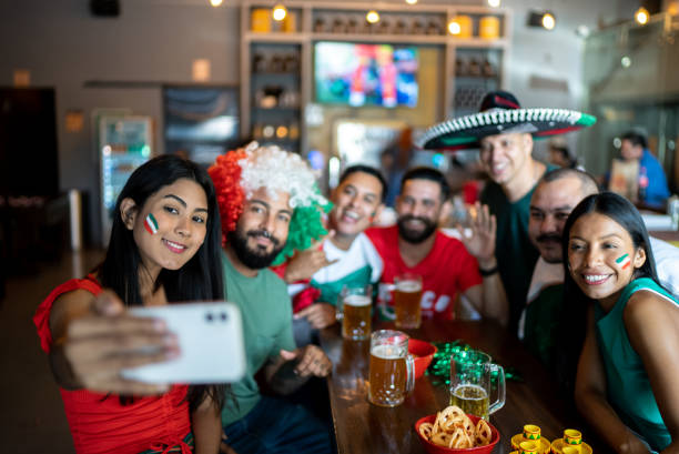 Friends doing a selfie using mobile phone at a bar
