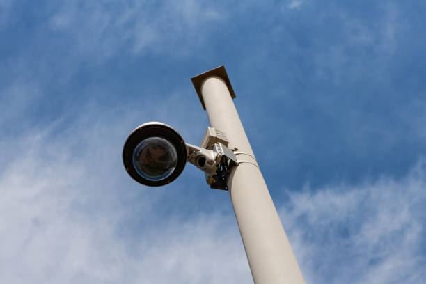 istock Street surveillance camera on a white metal pole 1408239804