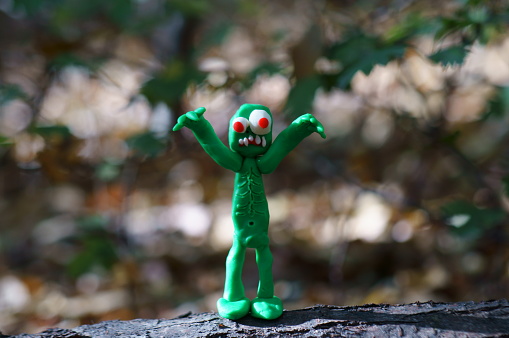 The zombie figurine is trying to scare. Funny monster made of plasticine.