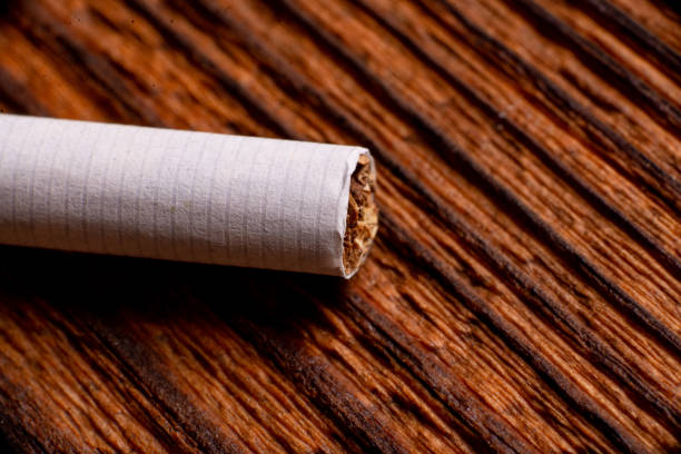 istock Cigarette close up on a wooden background. 1408240959