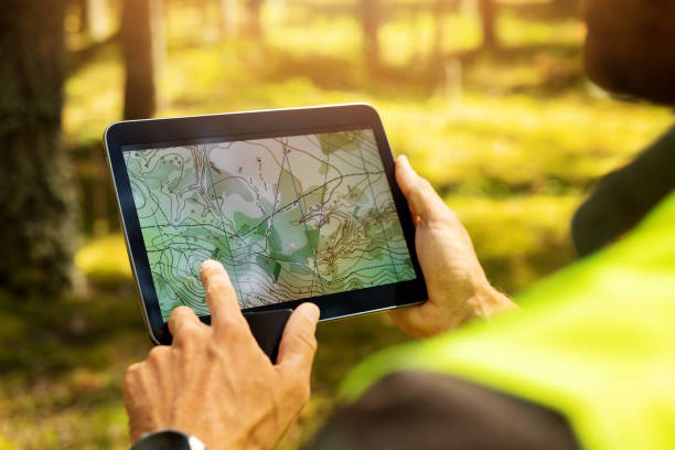 surveyor working with forest topography map in digital tablet. land surveying