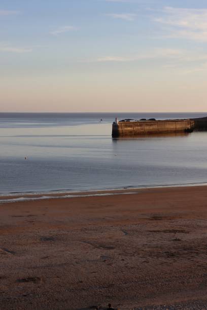 istock Pink sunset at the beach 1408242358