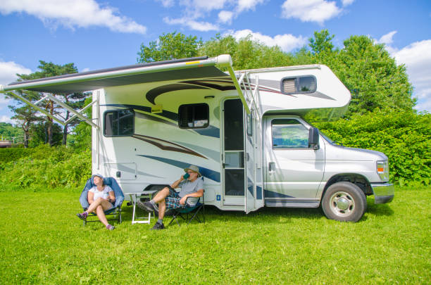istock Mature couple relaxing besides their motorhome 1408243875