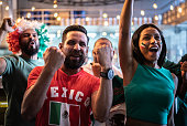 Mexican fans celebrating a goal in soccer game at bar