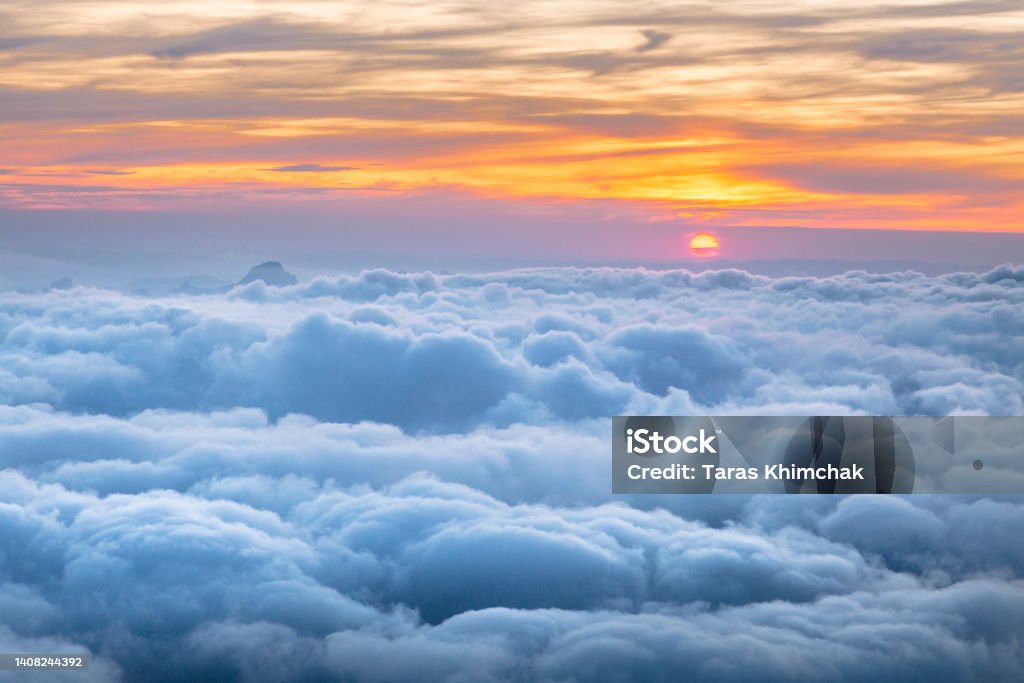 Beautiful clouds view from The Cosmiques Hut, Aiguille du Midi in the evening light, Chamonix-Mont-Blanc, France Cloud - Sky Stock Photo