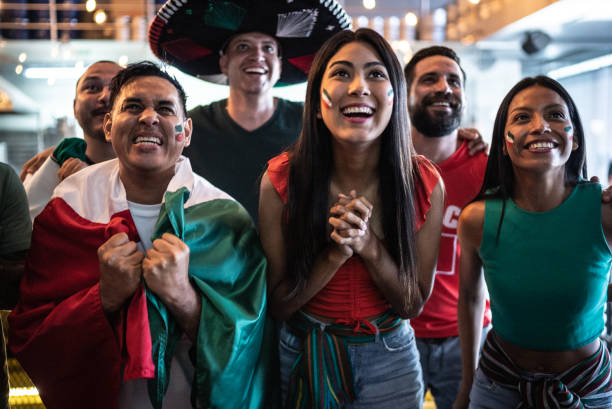 istock Mexican fans watching soccer game at bar 1408244414
