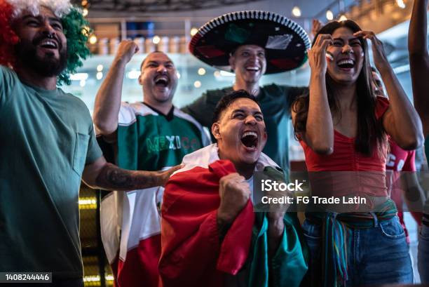 Mexican Fans Celebrating A Goal In Soccer Game At Bar Stock Photo - Download Image Now