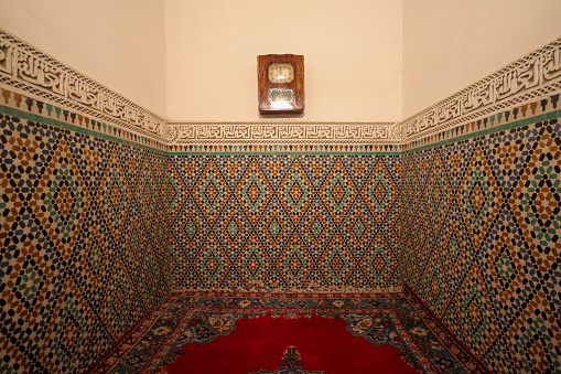 Meknes, Morocco-September 22, 2013: A room of the Moulay İsmail Tomb with a ceramic pattern and Arabic inscriptions on the walls.