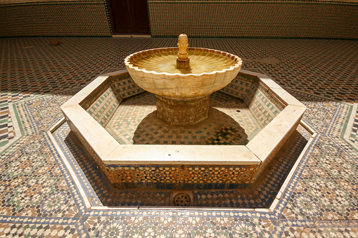 Meknes, Morocco-September 22, 2013: A small fountain decorated with zelish art in the courtyard of Moulay İsmail Tomb.