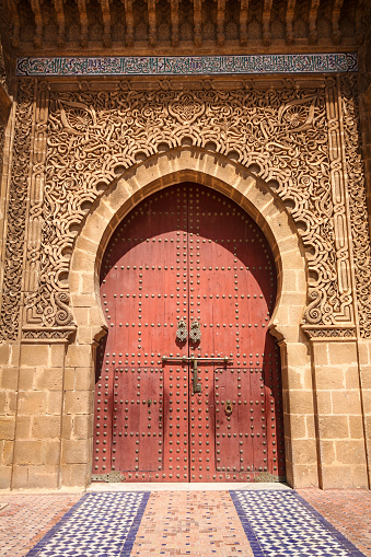 Meknes, Morocco-September 22, 2013: Stone carvings around the door and the outer door of Moulay Ismail Tomb.