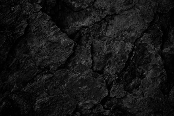 istock Black rock texture. Rough mountain surface with cracks. Close-up. Stone background with space for design. 1408248013