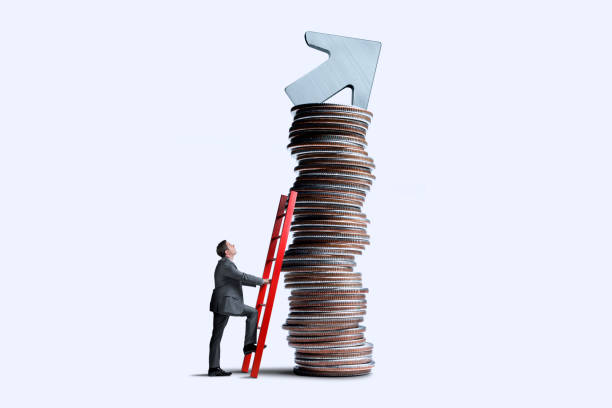 Man Leaning Ladder Against Coin Stack With Arrow on Top stock photo