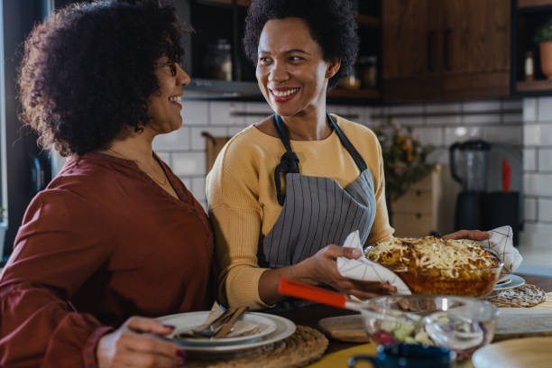 istock Happy lesbian couple cooking together 1408249012