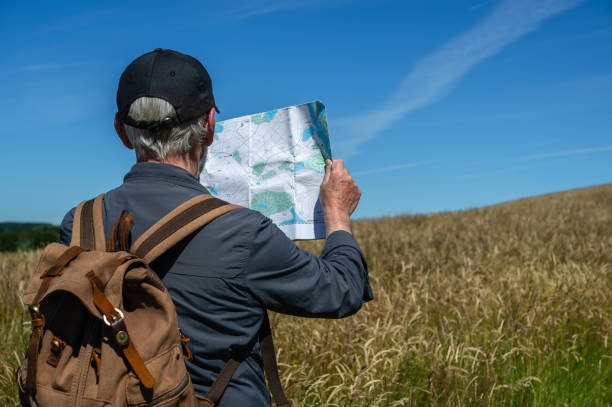 istock Senior man checking his map in a rural location 1408250724