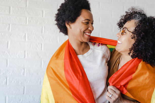 istock Lesbian women covered with rainbow flag 1408250733