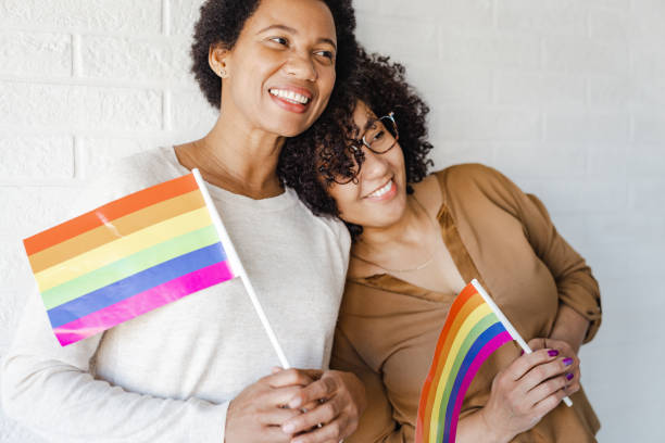 istock Happy girlfriends with LGBTQIA flags 1408250918