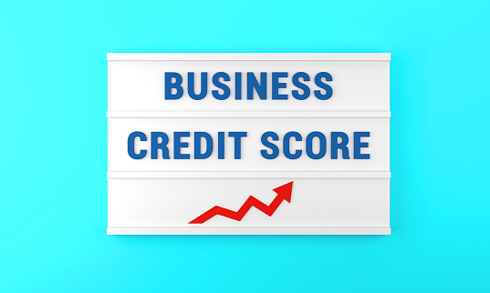 Success arrow and Business Credit Score text on the lightbox, on the blue background. Finance and Economy concept.