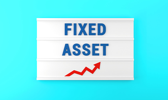 Success arrow and Fixed Asset text on the lightbox, on the blue background. Finance and Economy concept.