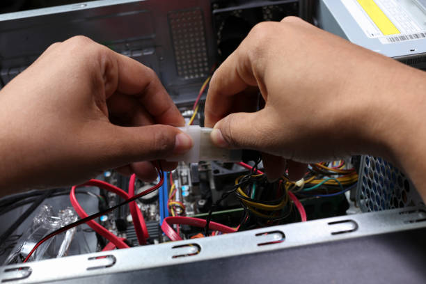 istock Close-up shot of a technician's hands connecting internal computer cables 1408252231