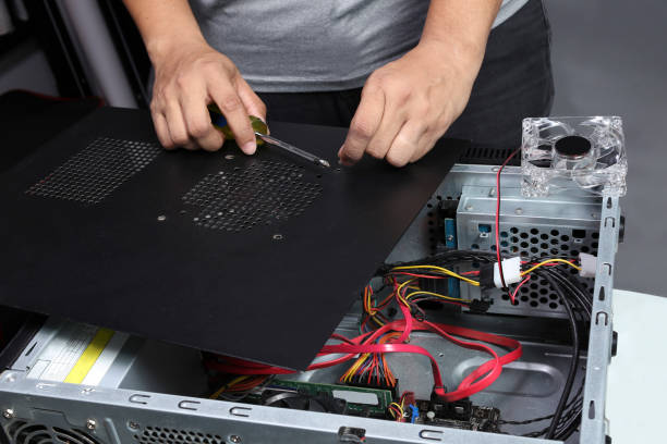 istock Technician removing the screw from the leg of a desktop PC 1408252365