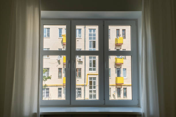 istock White window with curtains and city view. 1408254703