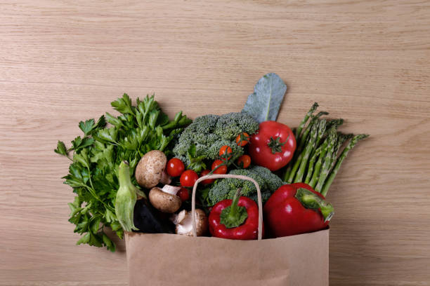istock Mixed organic produce in a brown paper bag. 1408254925
