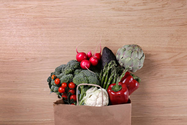 istock Mixed organic produce in a brown paper bag. 1408255027