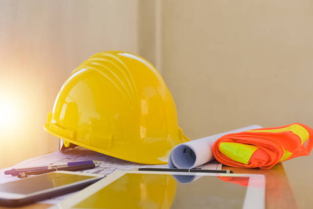 istock Yellow helmet hard hat safety for safety work and equipment on desk office, Engineering Engineer safety in work 1408256841