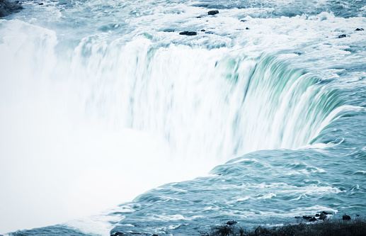 A long exposure used to soften the movement of water approaching and falling down Horseshoe Falls at Niagara.