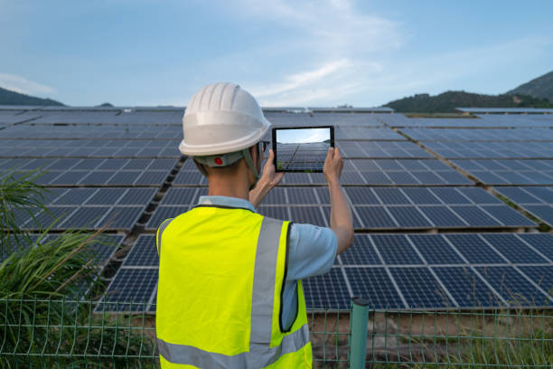 istock Male engineer using tablet to photograph solar power plant 1408258066