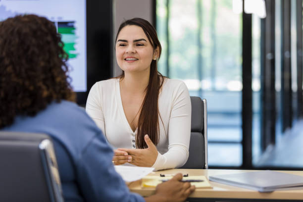 istock Young adult woman meets with unrecognizable human resources representative 1408262040