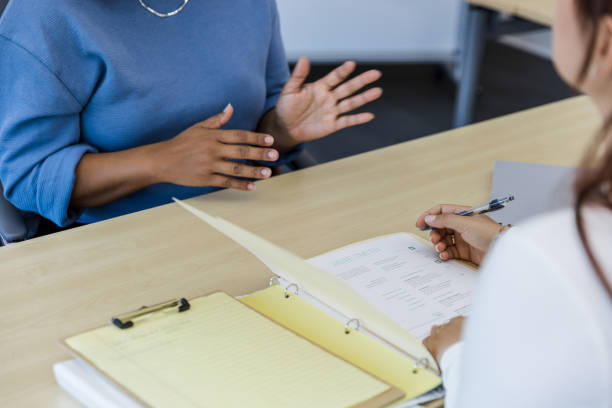 istock Woman gestures while answering interviewer's questions 1408262075