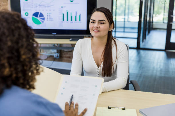 istock Unrecognizable female manager reviews young woman's qualifications 1408262085