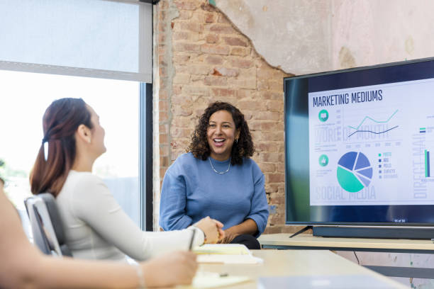 istock Co-workers laugh together during marketing meeting 1408262092