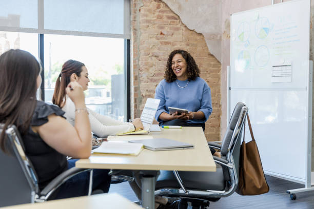 istock Female manager uses whiteboard to present budget 1408262099