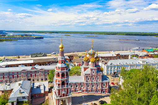Aerial drone view of Nizhniy Novgorod city center with Volga embankment and Cathedral of the Blessed Virgin Mary Stroganoff church during sunny day, Russia.