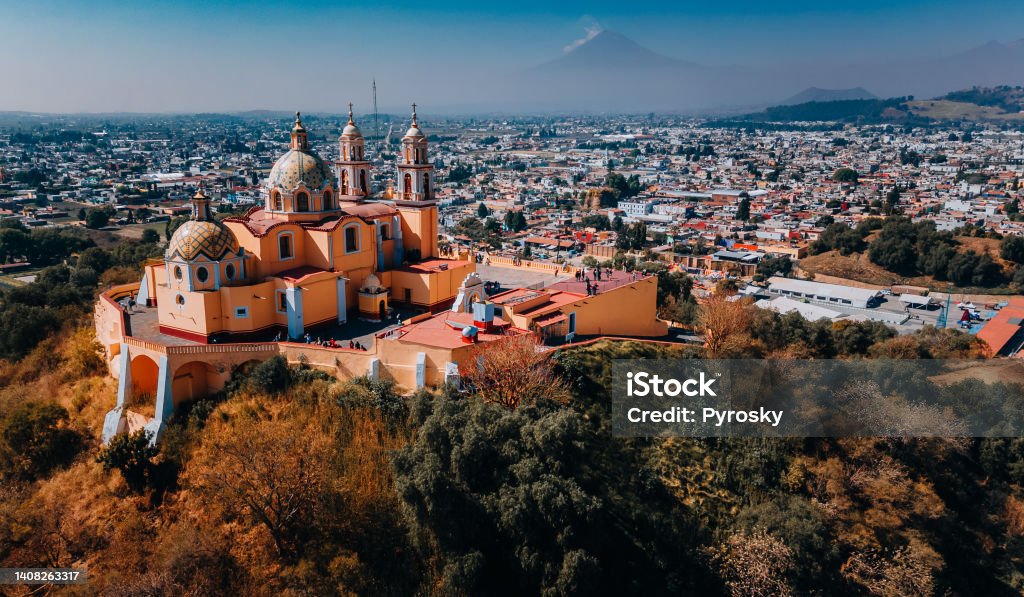 Church known as Our Lady of Remedies in Cholula, Mexico Aerial view of the city Puebla in Mexico with a Popocatepetl volcano in the background . Mexico Stock Photo