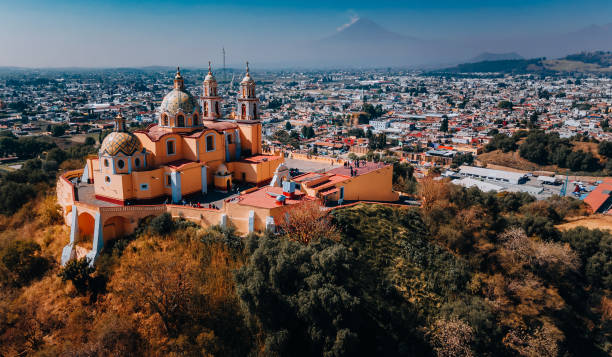 Church known as Our Lady of Remedies in Cholula, Mexico Aerial view of the city Puebla in Mexico with a Popocatepetl volcano in the background . popocatepetl volcano photos stock pictures, royalty-free photos & images
