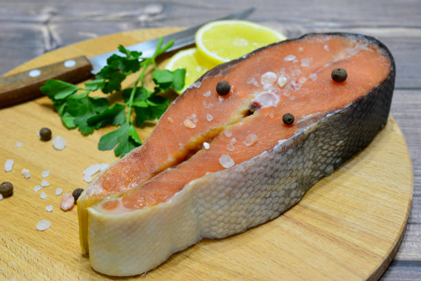 istock salmon steak with salt and allspice on cutting board, close-up 1408264918