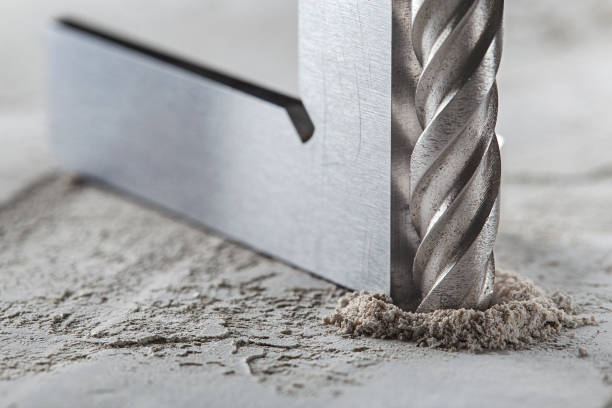 istock drill bit make holes in concrete wall with steel triangle. Building work industry. 1408266490