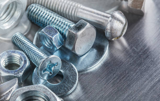 istock set of different nuts, bolts, screws, washers and drill bits,thread tap and mill cutters on steel plate background. Locksmithing deal. 1408266515