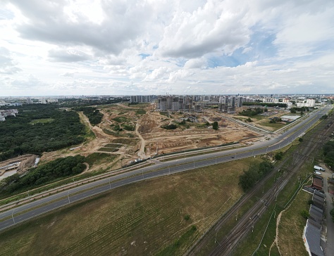Construction of a city block. The railway line and motorway pass nearby. Aerial photography.
