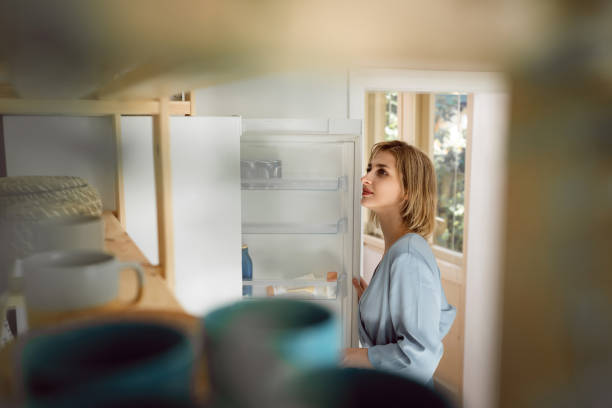 istock Young Caucasian woman doing chores in the kitchen 1408268821