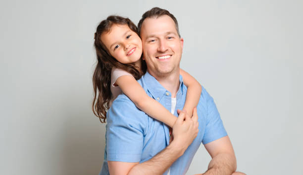 istock Father with his daughter on studio white background 1408270463