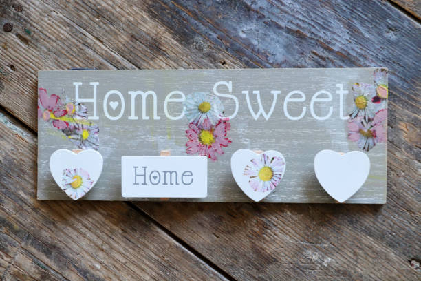 Home sweet home on wooden table stock photo