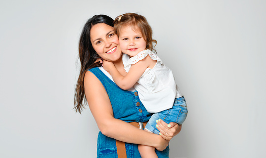 A Mother with his daughter on studio white background