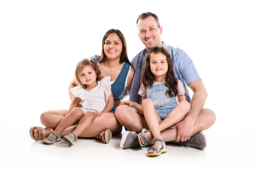 A family with his two daughter girl on studio white background